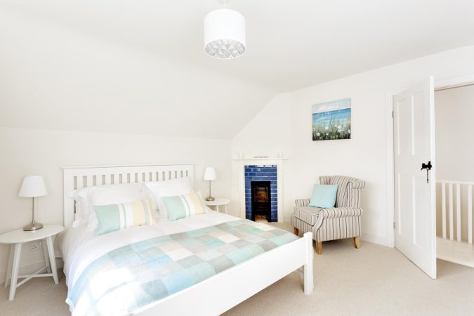 Cockley House Blakeney bedroom with feature fireplace